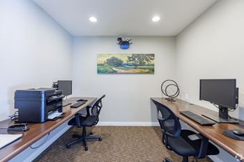 A room with two desks and two computers